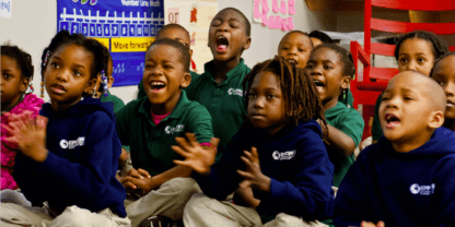 A group of young students gathered on the floor for circle time.