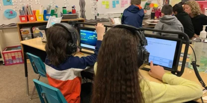 Two students looking at tablets working on eSpark in classroom